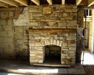 Interior lime plaster repair and masonry work on stone building